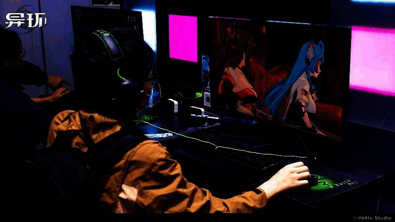 玩家在试玩区体验游戏，工作人员在一旁指导操作